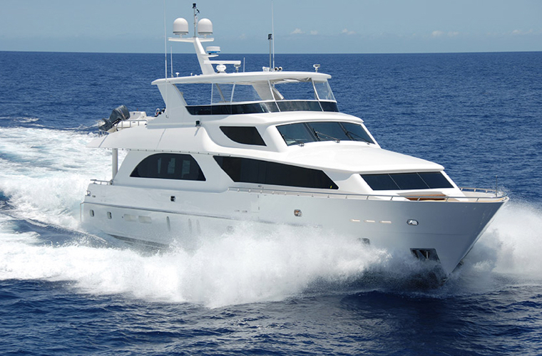 A white boat speeds through open water.