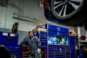 A mechanic at Chapman Auto Group with health insurance coverage from Imagine360 works on a car in the garage.